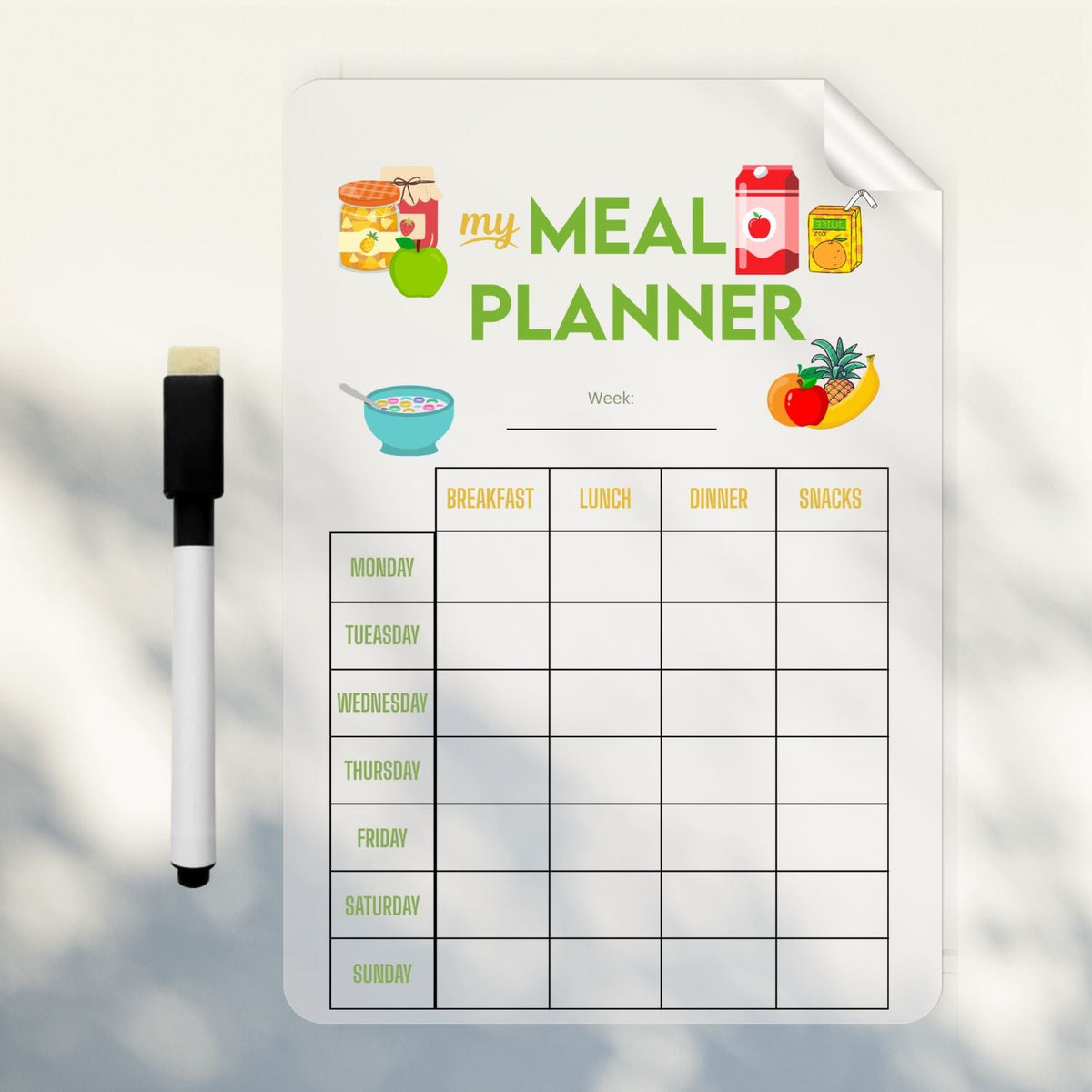 Reusable meal planner wall sticker with the week's dinners written in marker